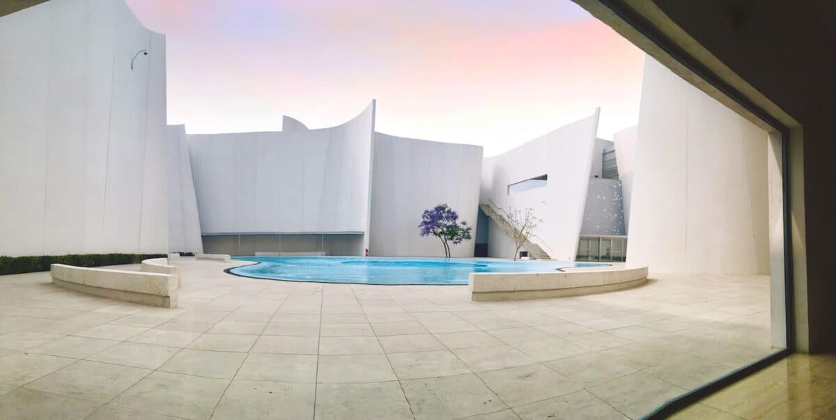 white concrete building with swimming pool